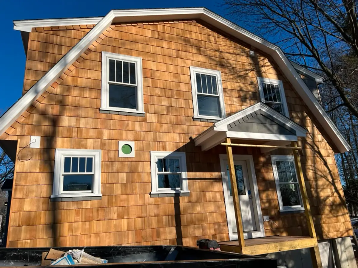 Front elevation of a Reading, MA addition clad in western red cedar with an entry portico