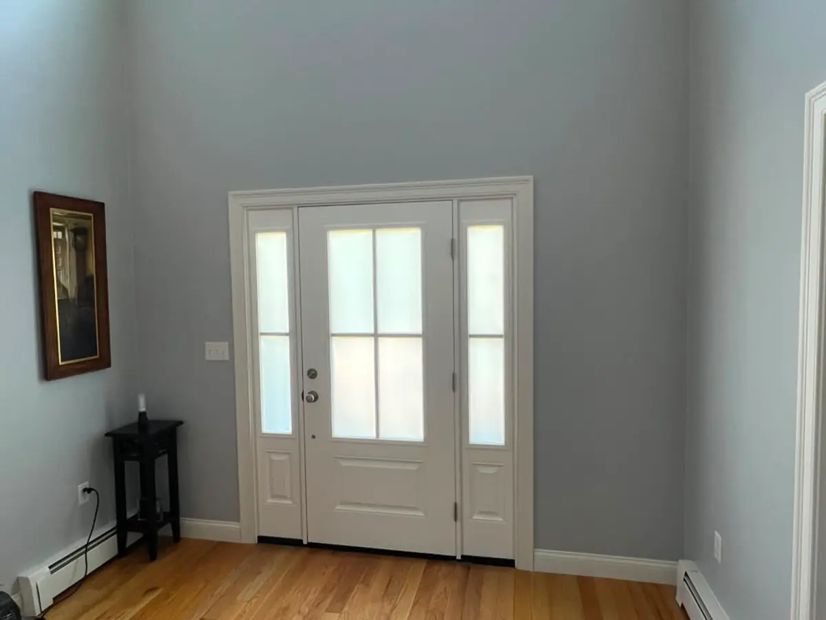 Interior view of a new entry door with frosted sidelights and full casing in Norfolk, MA