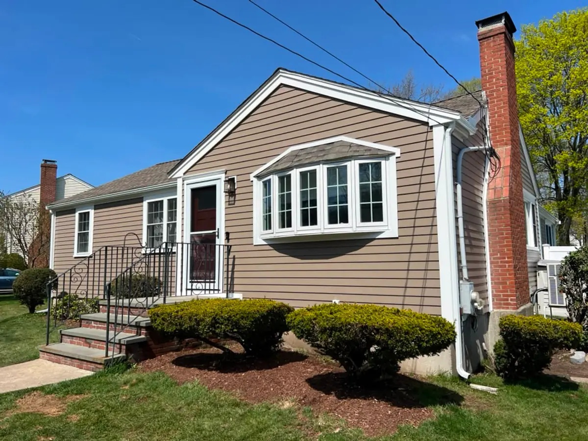 Side elevation in Woburn, MA with a new bay window, wrapped trim and seamless gutters