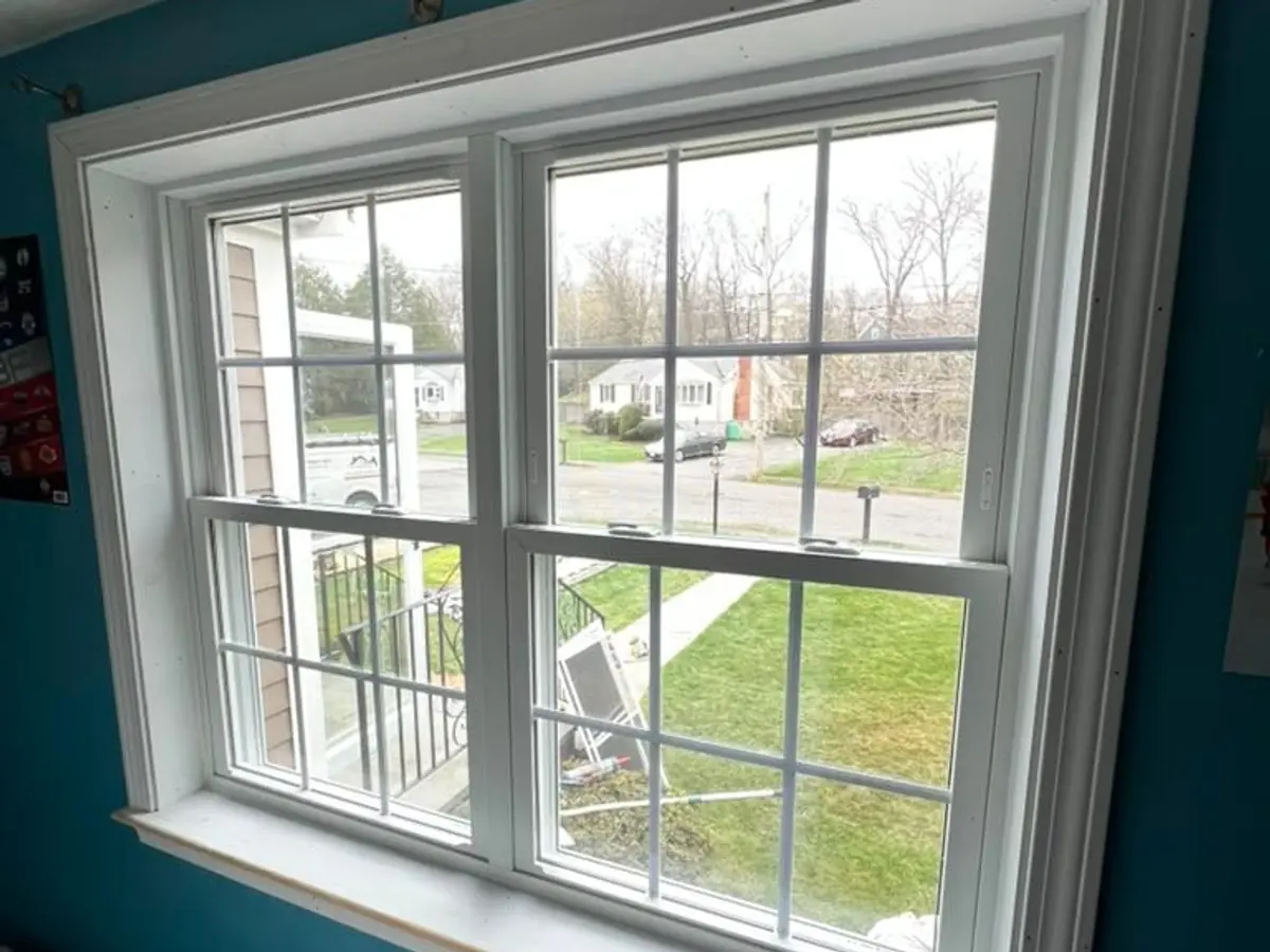 Interior view of a new double-hung replacement window with white casing in Woburn, MA